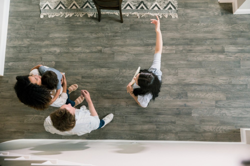 High Angle View Real Estate Agent Showing Family New Home