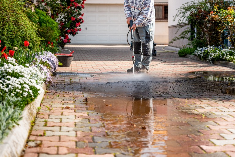man pressure washing